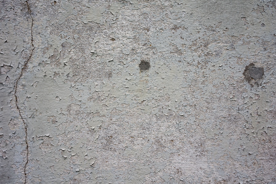 Photo 25161: Worn, plastered, grey wall with dark grey spots