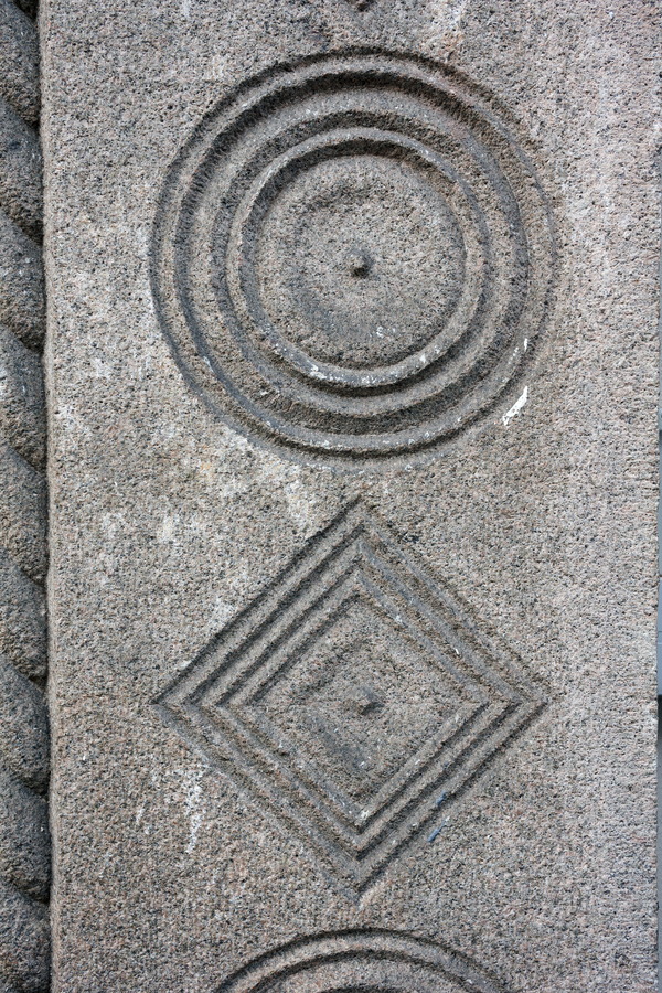 Photo 25200: Grey, granite wall stone with circle and diamond signs