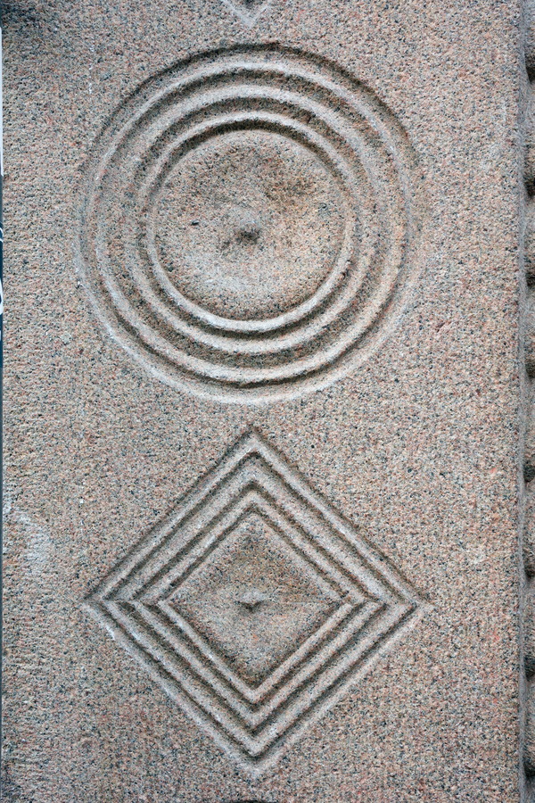 Photo 25201: Grey, granite wall stone with circle and diamond signs.