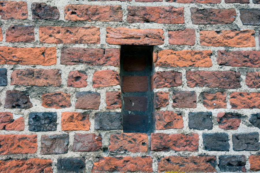 Photo 25313: Red brick wall with red and black bricks and narrow indentation