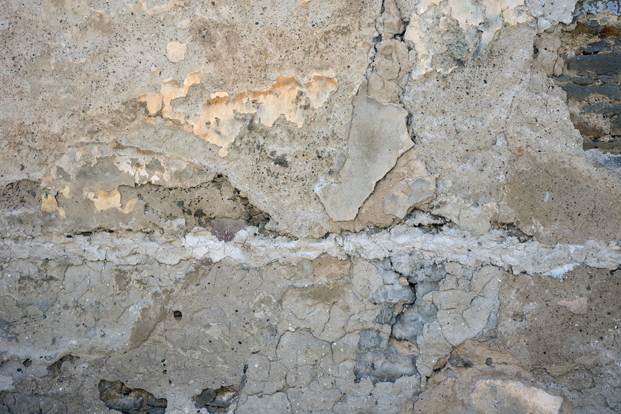 Photo 25428: Decayed, plastered, grey wall with yellow and black traces