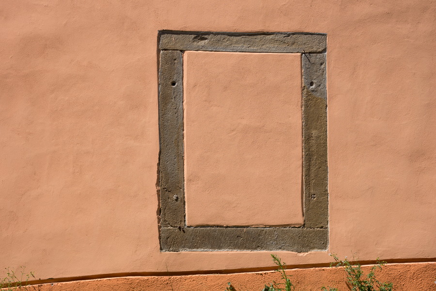 Photo 25444: Orange, plastered wall with a rectangular stone frame