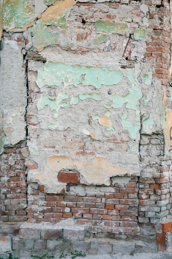 Photo 25614: Decayed, plastered, red brick wall with remains of light green and light yellow colours