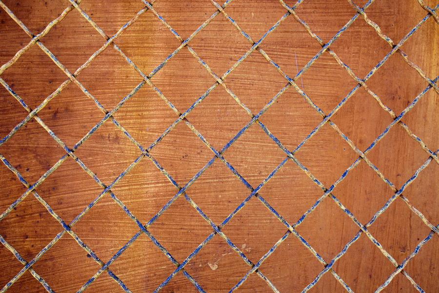 Photo 25727: Yellow and blue metal net in front of an orange wall