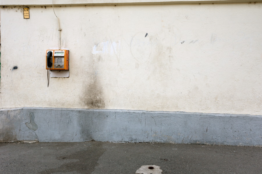 Photo 25809: White, plastered wall with a pay-phone