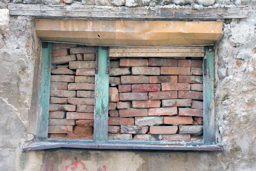 Photo 26221: Decayed, plastered wall with light green window blocked by loose bricks