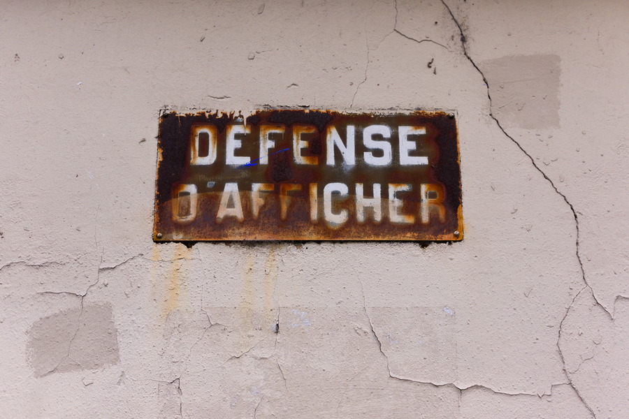 Photo 27404: Worn, light red, plastered wall with text 