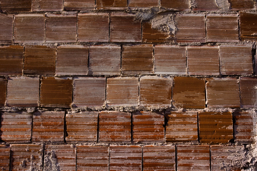 Photo 27419: Rough, red wall of bricks.