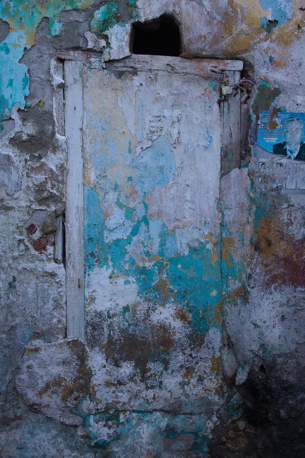 Photo 27423: Decayed, grey, plastered wall with wooden hatch in many colours