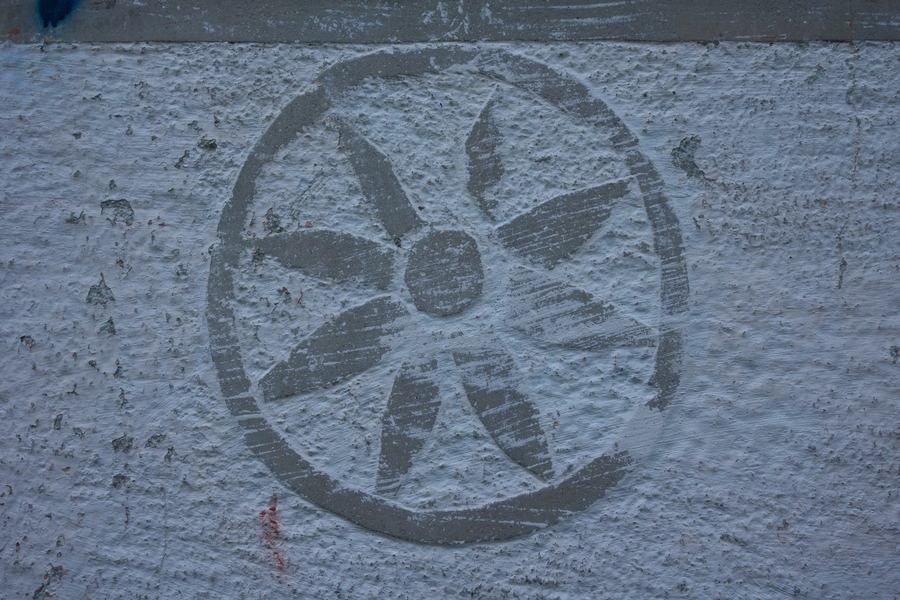 Photo 27426: Grey stone wall with flower symbol