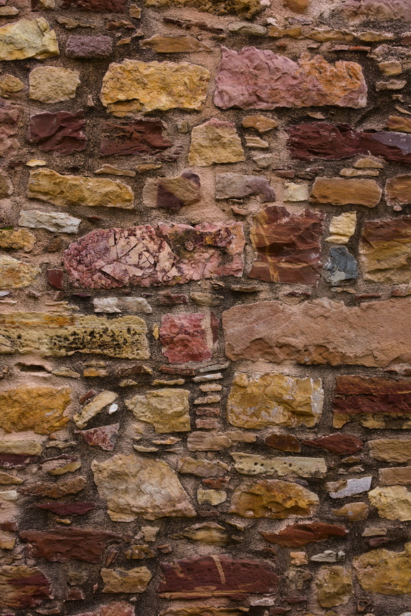 Photo 27437: Stone wall with yellow, brown and red stones. Well maintained.