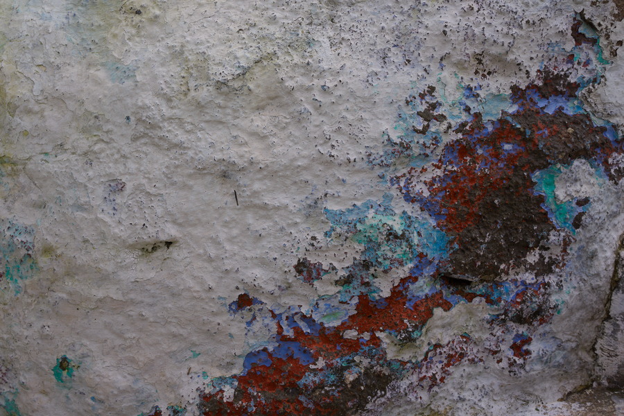 Photo 27452: Worn, white, plastered wall with red, purple, violet and turquoise colours