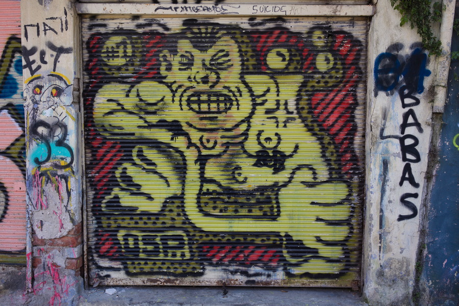 Photo 27472: Security shutter with large grafitti: Angry, yellow man