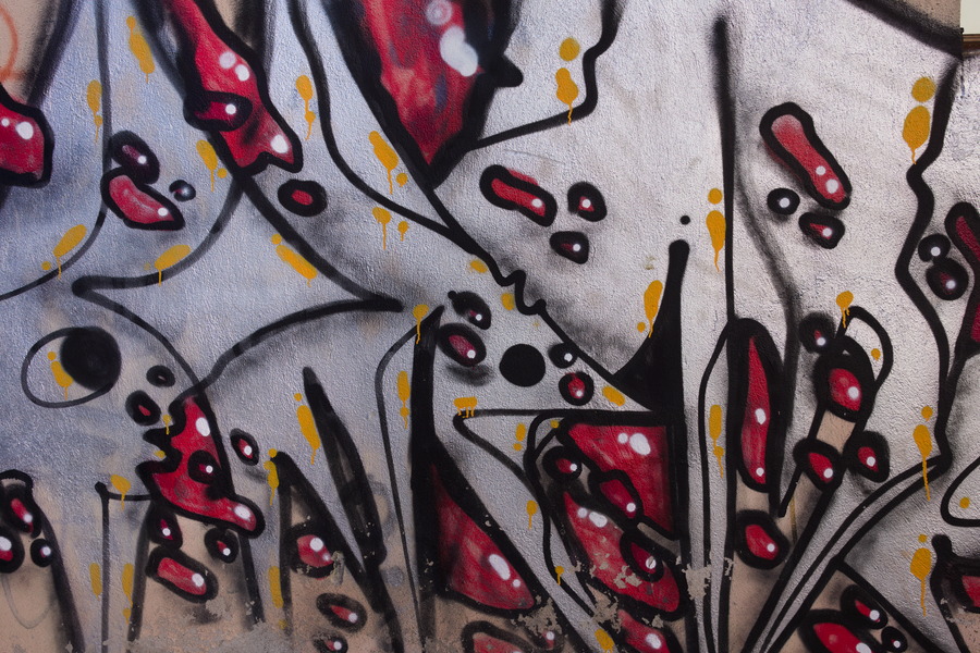 Photo 27476: White and yellow plastered wall with red and black grafitti