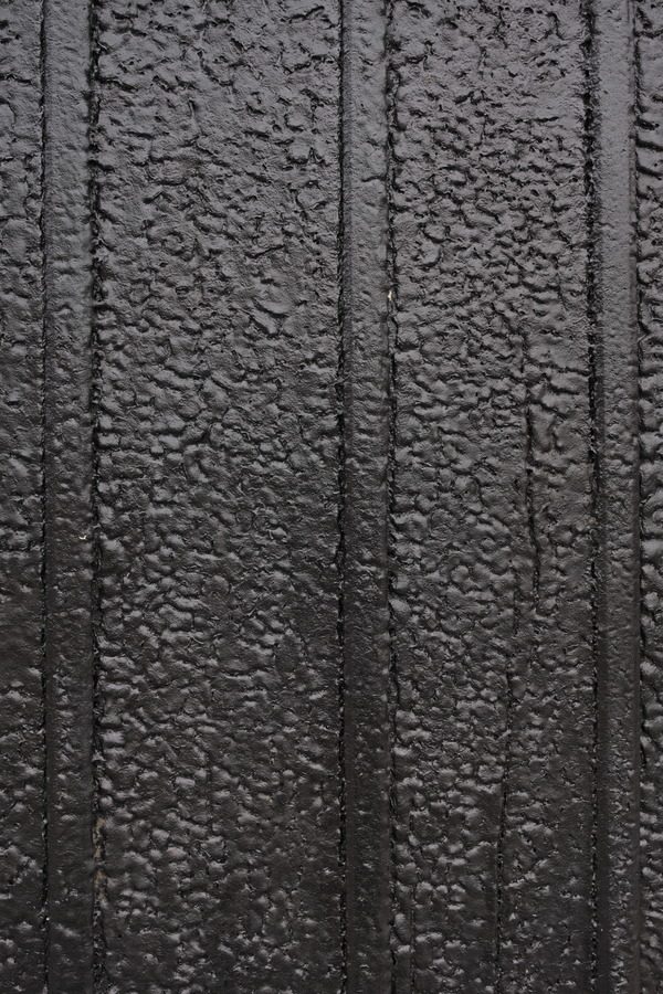 Photo 27493: Black, tarred board wall.