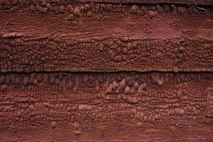 Photo 27497: Worn, red, uneven board wall