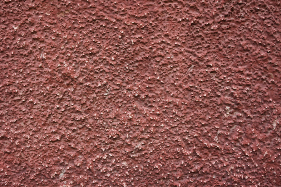 Photo 27500: Red, plastered wall with white spots.