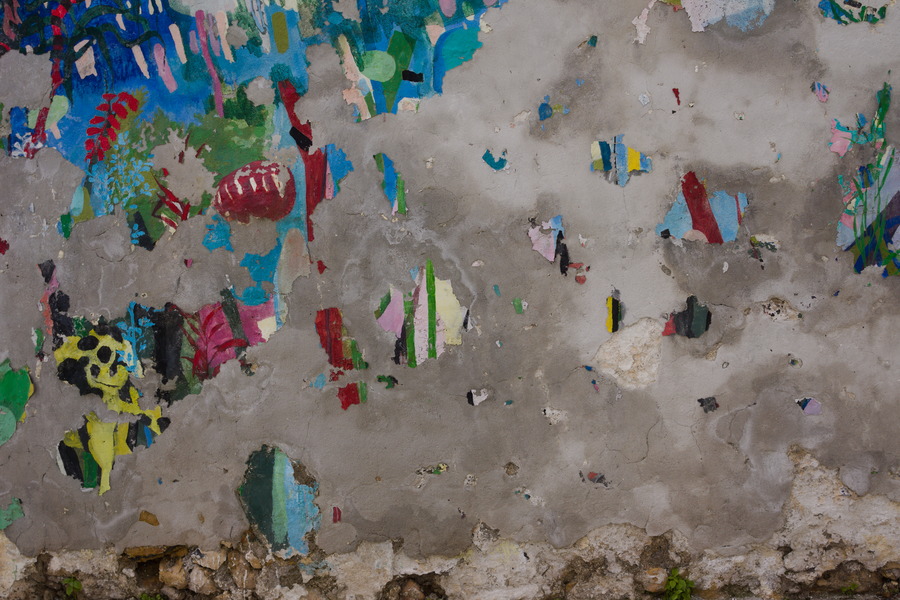 Photo 27506: Decayed, grey, plastered wall with remains of posters.