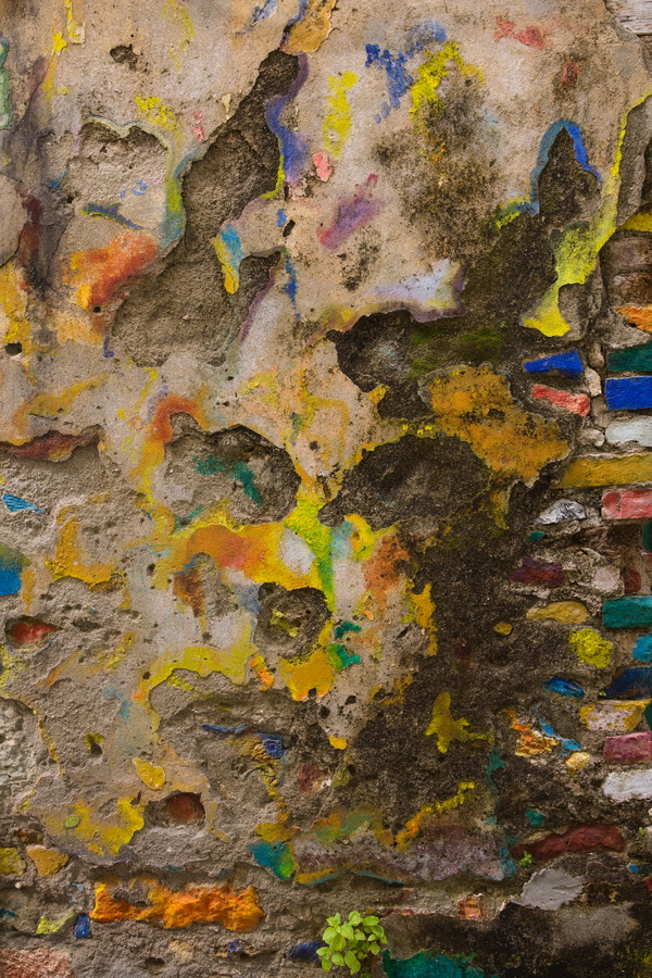 Photo 27507: Decayed, yellow, plastered wall with many colours