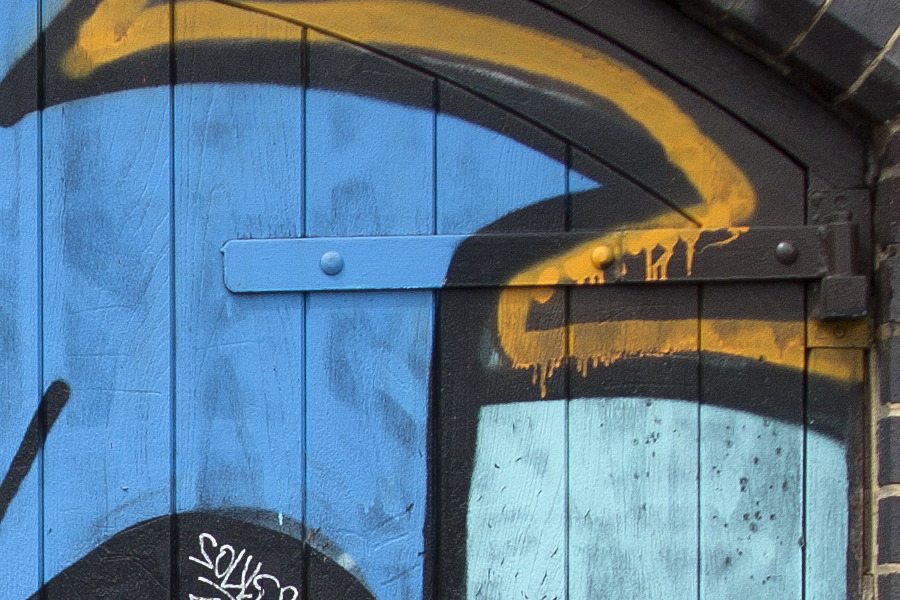 Photo 05146: Door of boards with large grafitti in blue-red-green-white