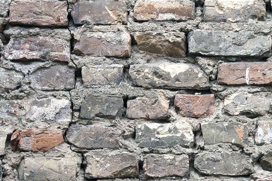 Photo 19171: Worn brick wall with yellow, red, black and blue bricks