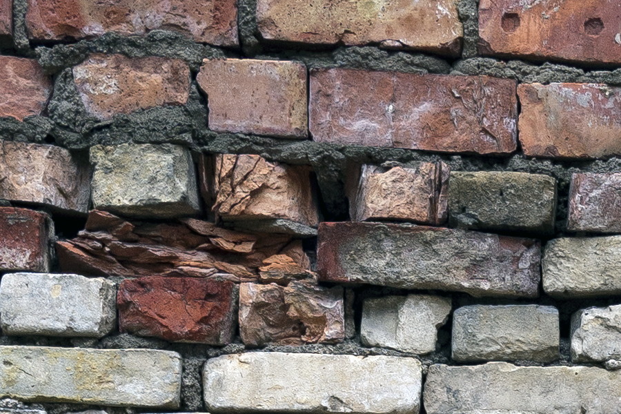 Photo 19175: Worn wall made of red, white and orange bricks