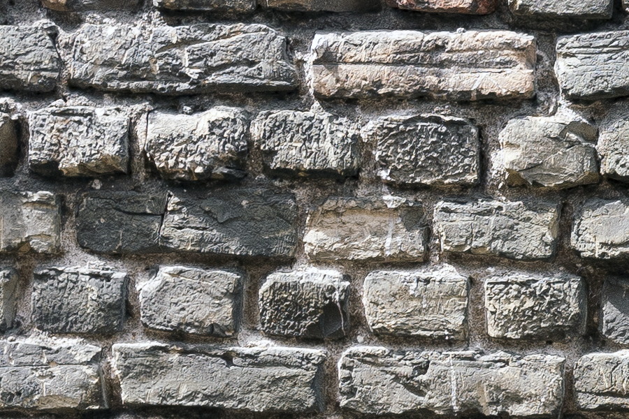 Photo 19299: Worn brick wall with yellow and black bricks