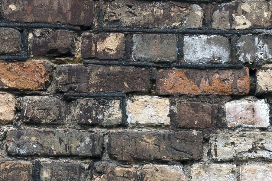 Photo 19301: Worn brick wall with red, white and brown bricks