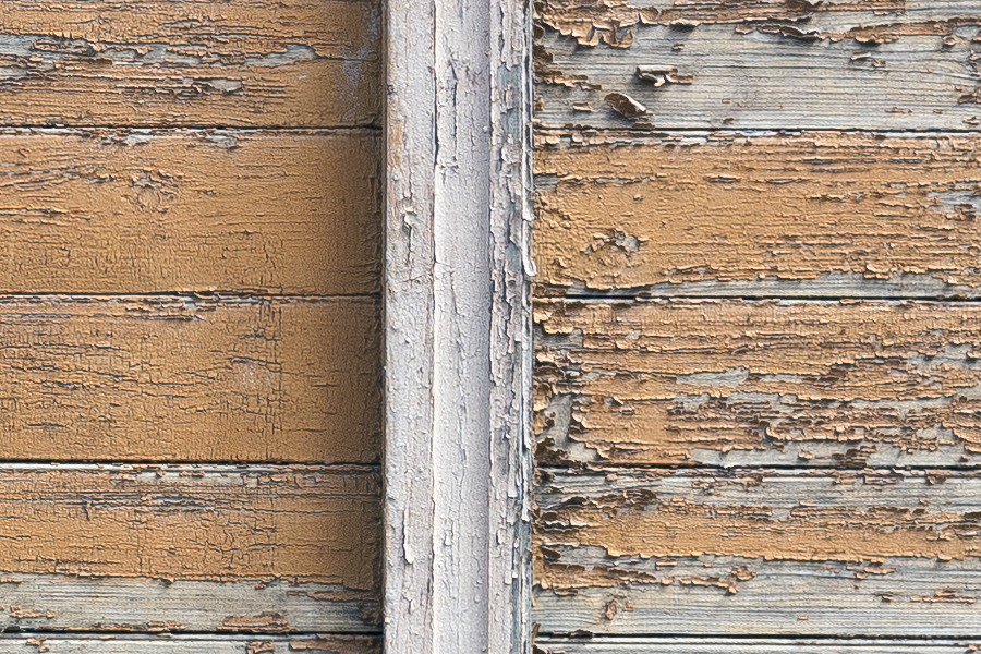 Photo 19781: Decayed, light brown wall of planks with empty, white window frame