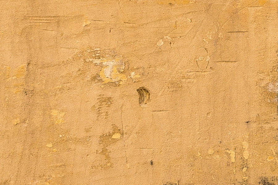 Photo 24142: Worn, yellow sandstone wall.