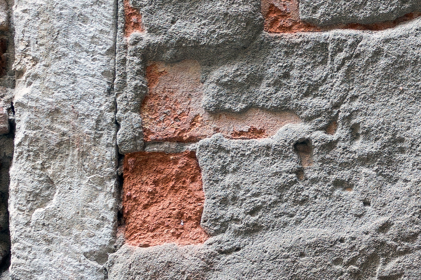 Photo 24766: Red brick wall with decayed, grey plaster