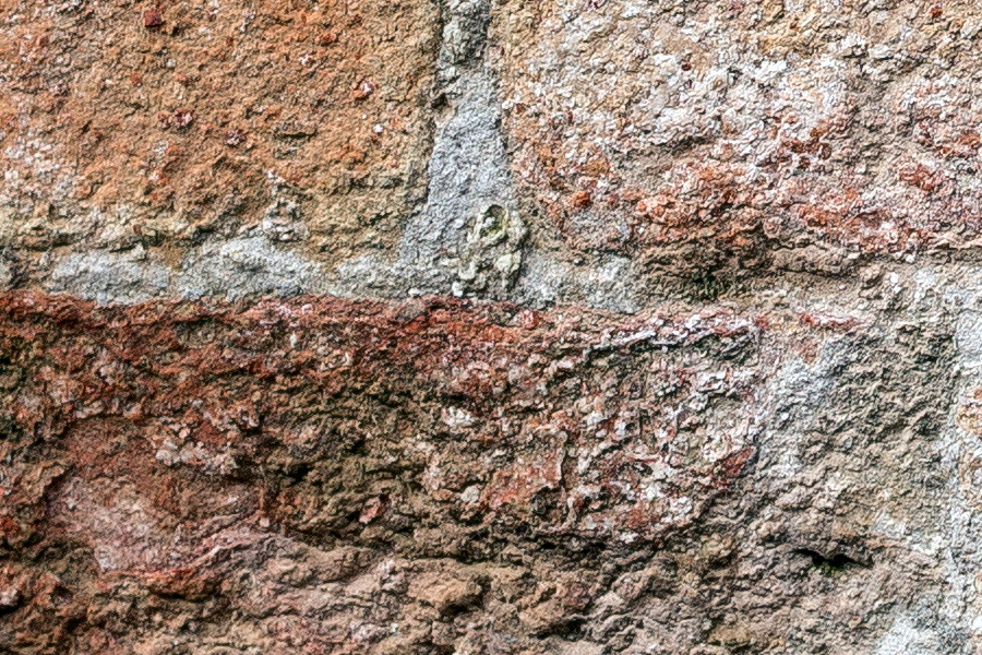 Photo 24804: Worn brick wall in red and yellow colours.