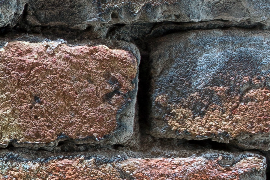 Photo 24816: Worn brick wall without mortar in blue, yellow and red colours