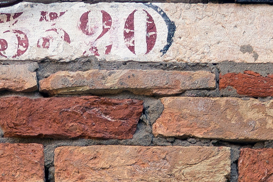 Photo 24871: Worn, red and white brick wall with remains of a doorway