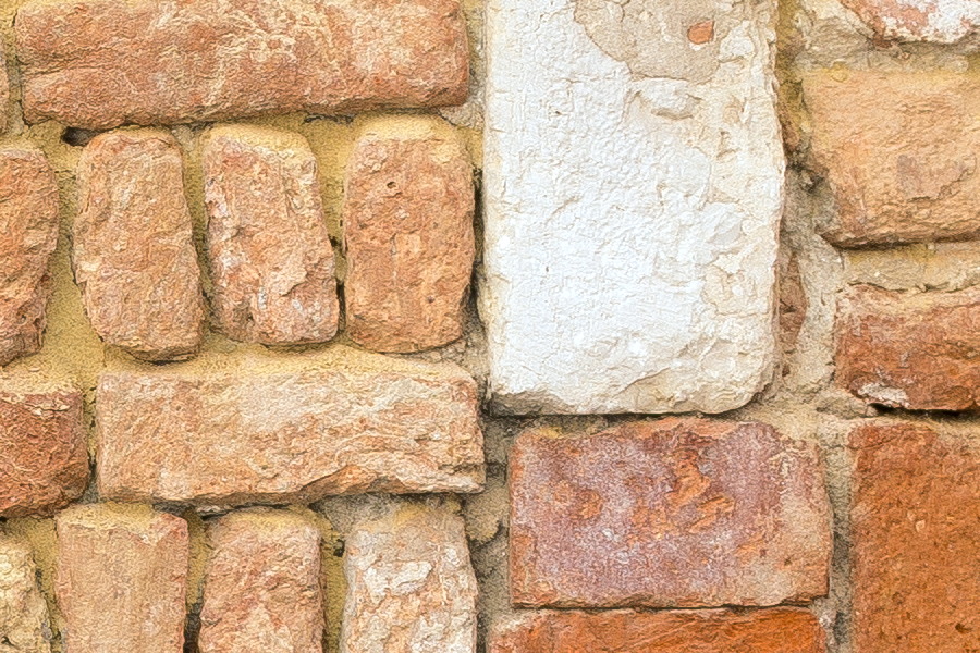 Photo 24872: Worn, red and yellow brick wall with remains of a window