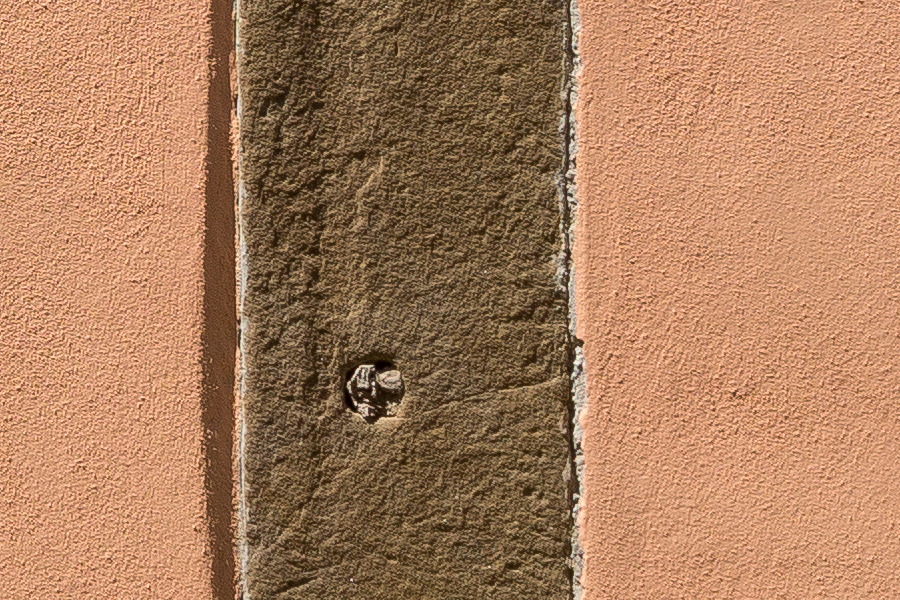 Photo 25444: Orange, plastered wall with a rectangular stone frame