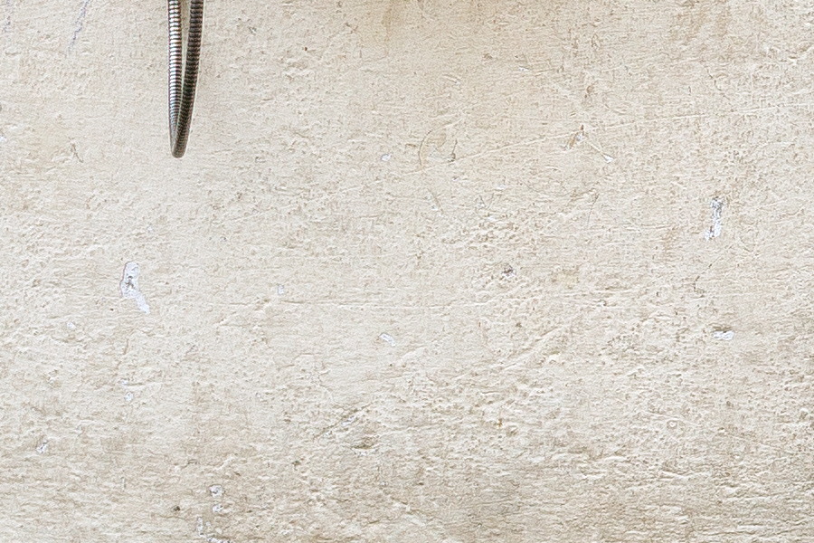 Photo 25809: White, plastered wall with a pay-phone