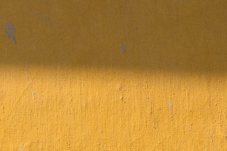 Photo 25979: Yellow, plastered wall with sign 