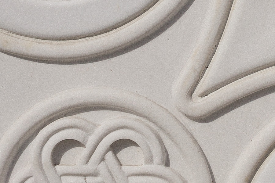 Photo 26390: New, white relief of plaster with various symbols