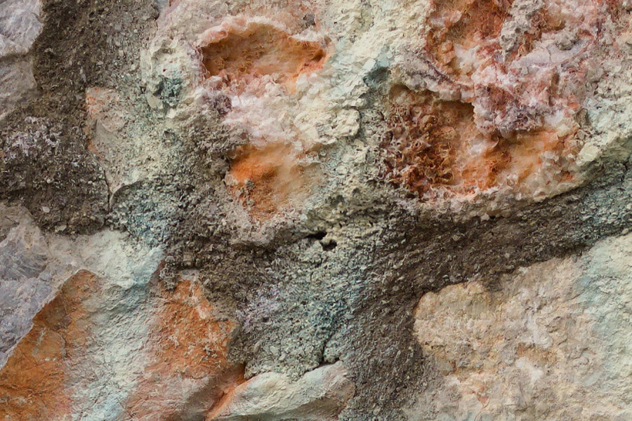 Photo 27433: Stone wall with grey, blue, and red stones and grafitti