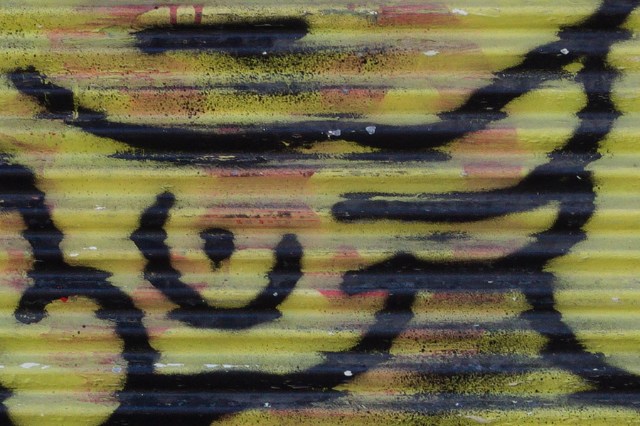 Photo 27472: Security shutter with large grafitti: Angry, yellow man