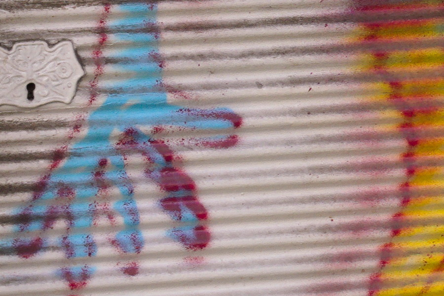 Photo 27479: Security shutter with grafitti: Blue, black and yellow man